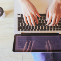 Someone typing on the computer from birds eye view